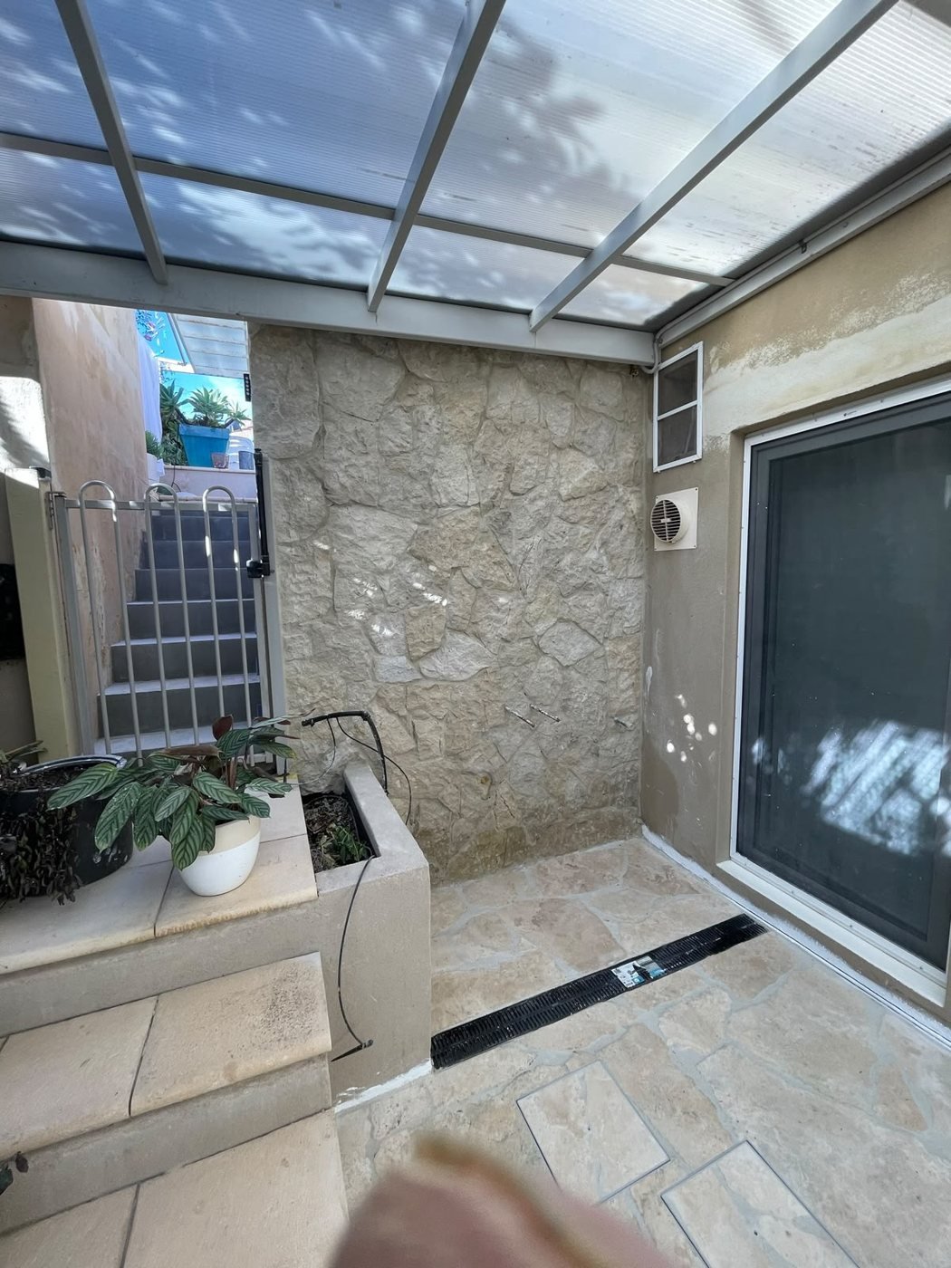 Alfresco Courtyard — stone feature wall and travertine courtyard floor, Fremantle, WA